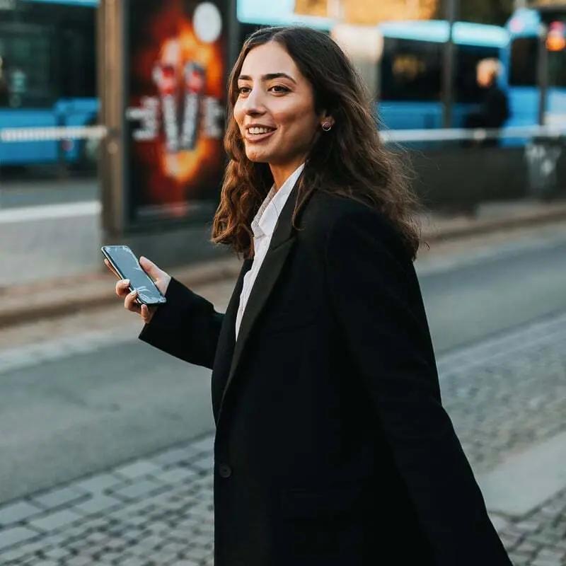 Person håller telefon vid gatuövergång